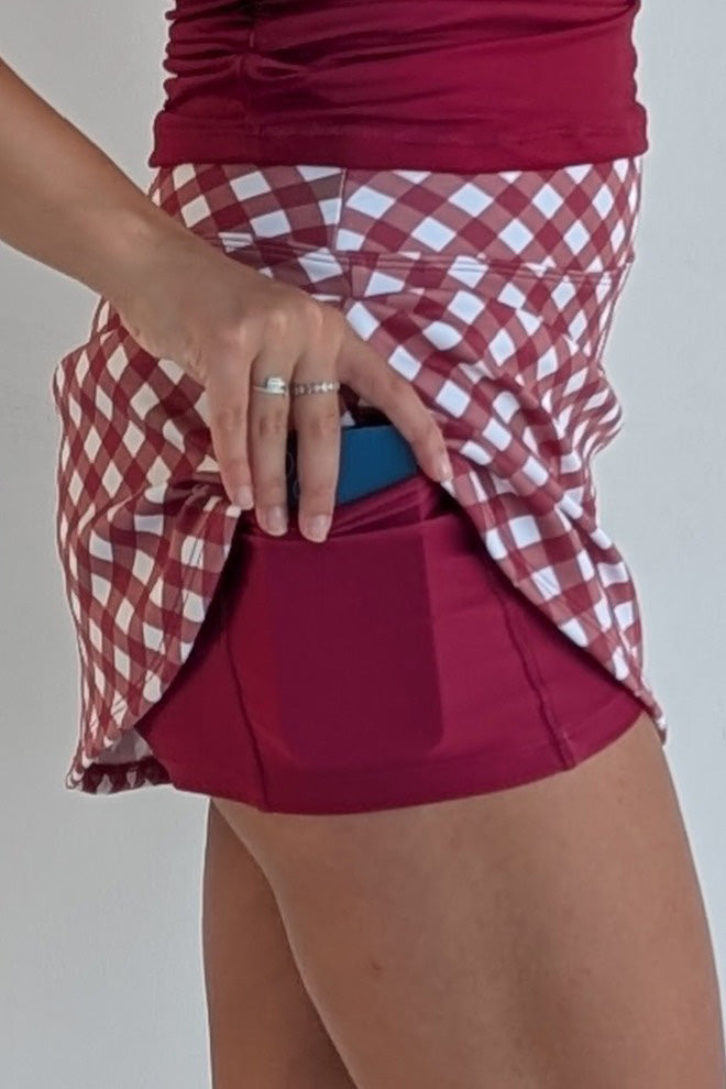 Form Fitting crimson gingham miniskirt with built in shorts and pockets; great for gameday or hanging out with friends.
