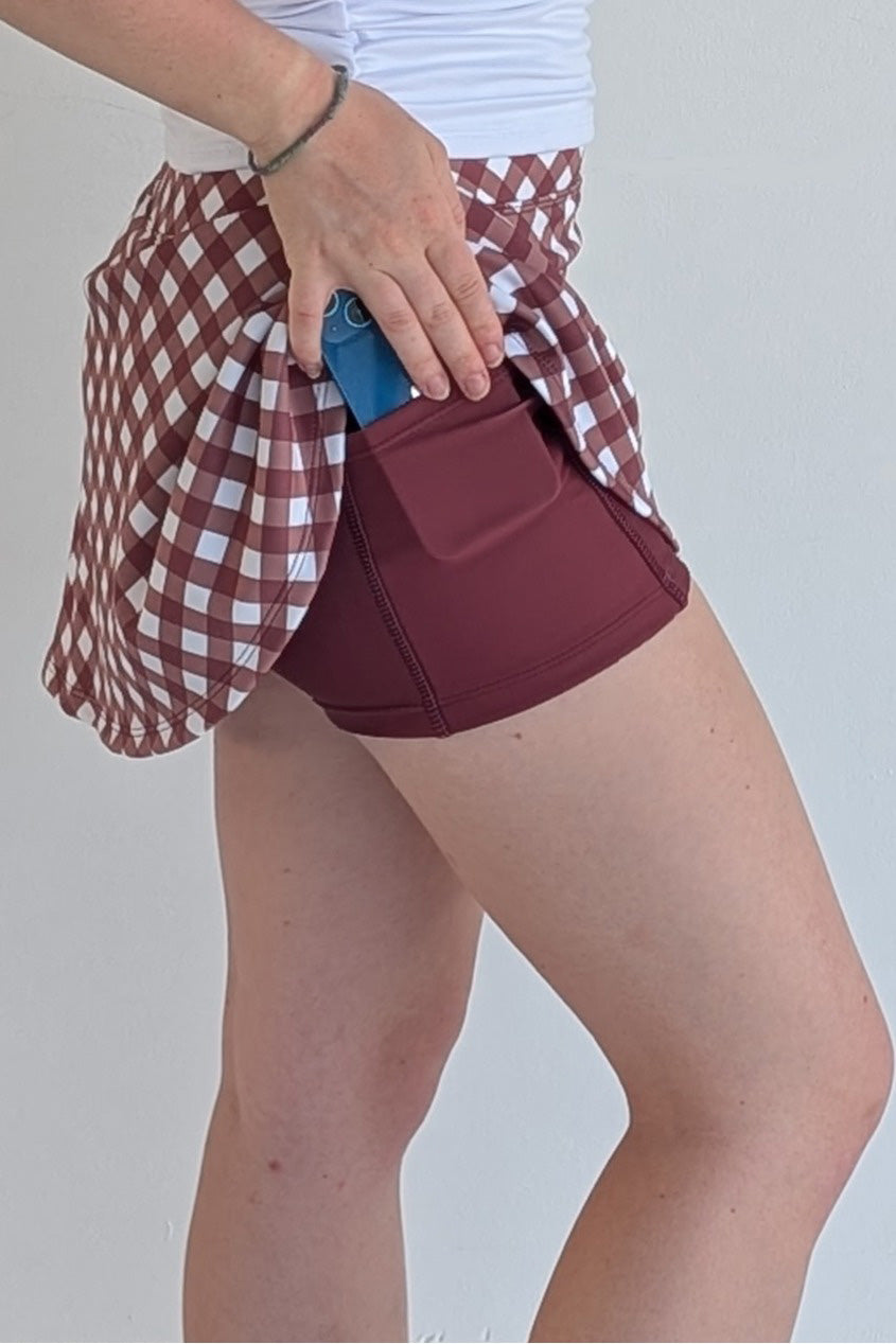 Relaxed back maroon gingham miniskirt with built in shorts and pockets; great for gameday or hanging out with friends.