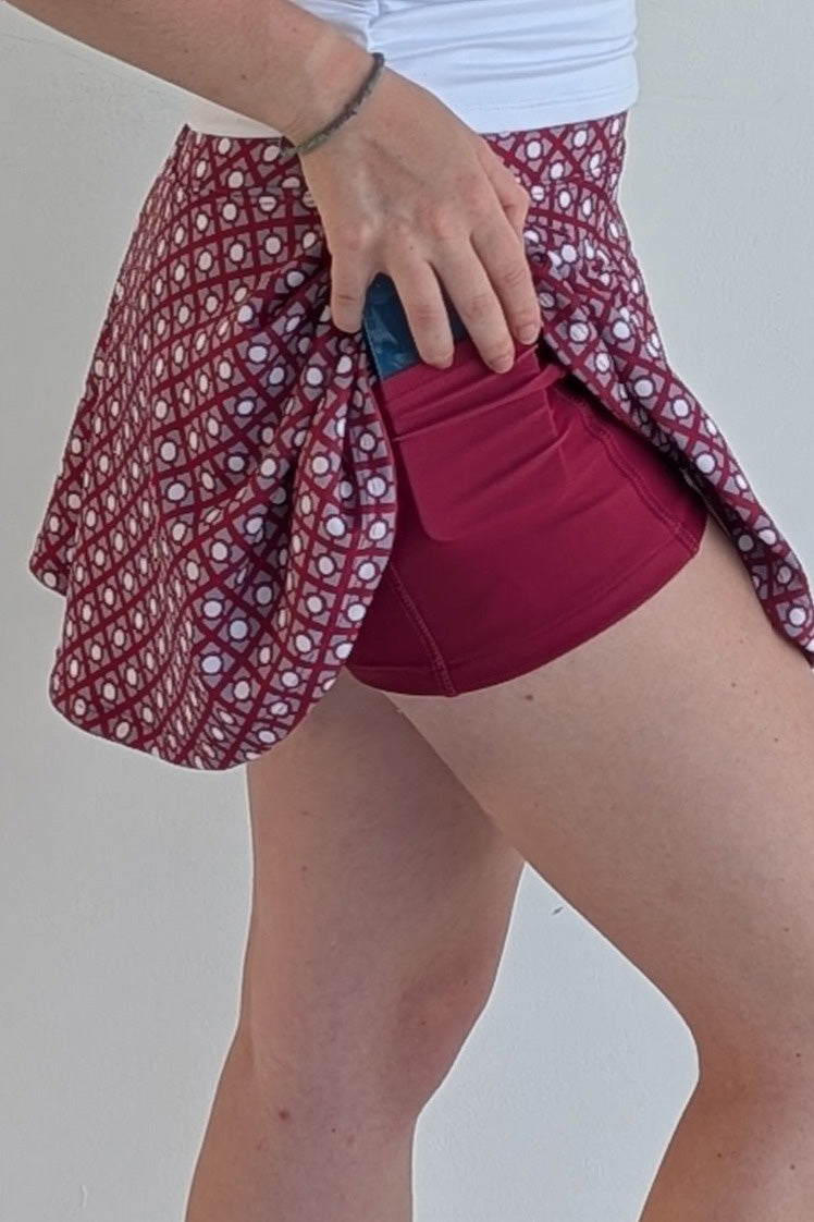 Full bodied crimson miniskirt with geometric print and built in shorts and pockets; great for gameday or hanging out with friends.