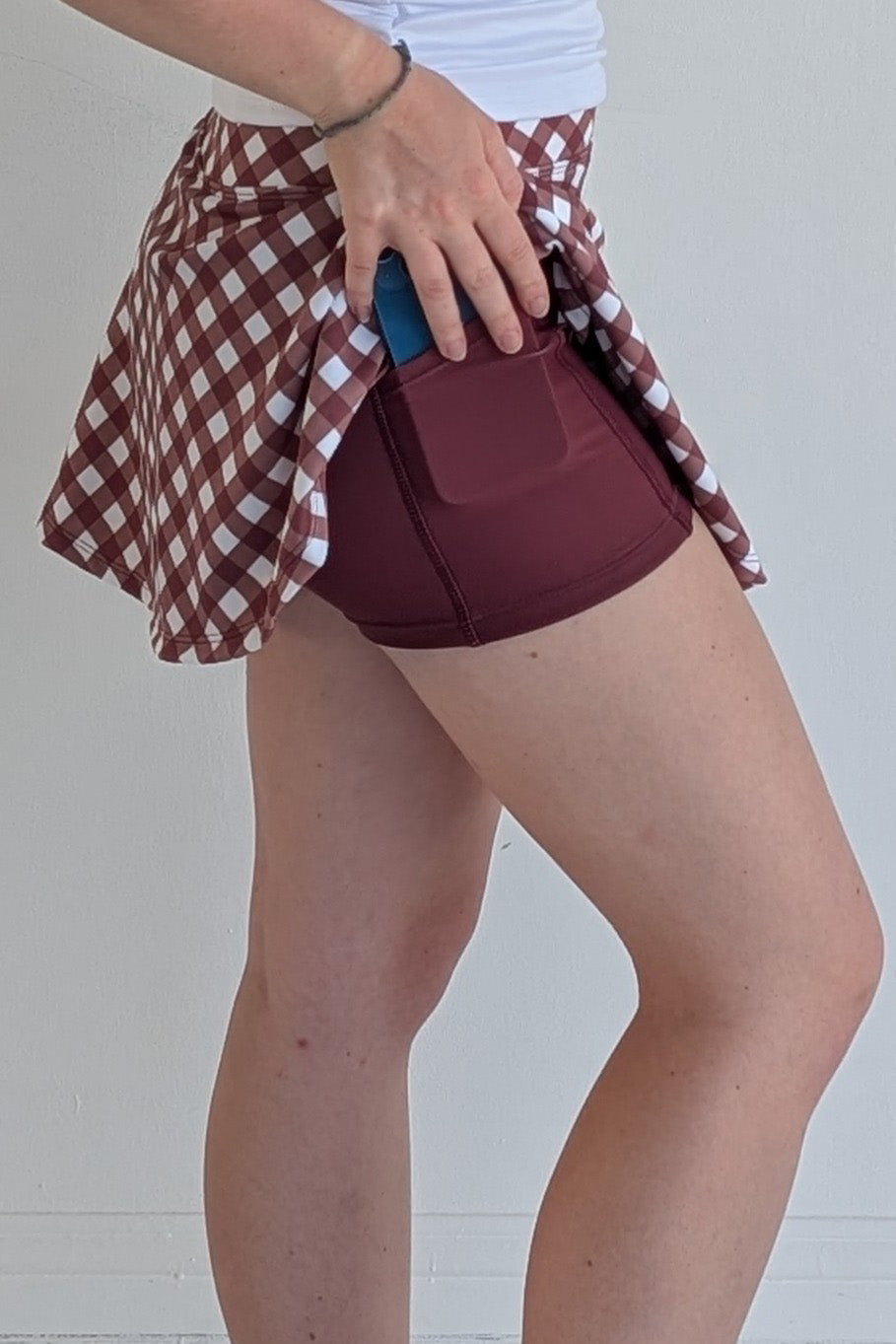 Full bodied maroon gingham miniskirt with built in shorts and pockets; great for gameday or hanging out with friends.