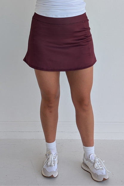 Form Fitting solid maroon miniskirt with built in shorts and pockets; great for gameday or hanging out with friends.