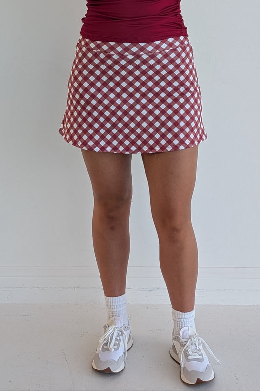 Form Fitting crimson gingham miniskirt with  built in shorts and pockets; great for gameday or hanging out with friends.