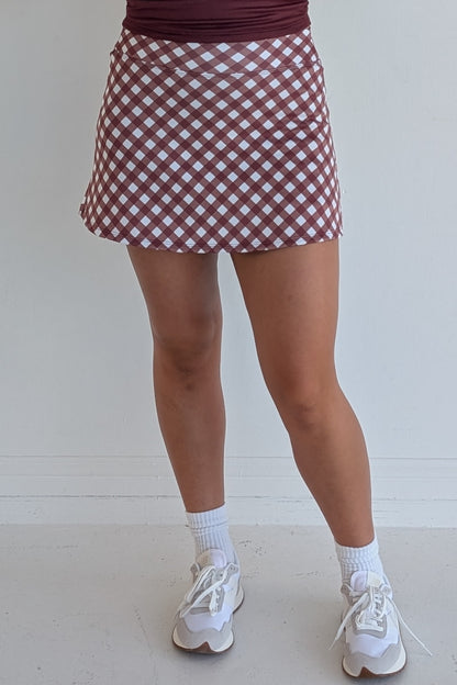 Form Fitting maroon gingham miniskirt with  built in shorts and pockets; great for gameday or hanging out with friends.