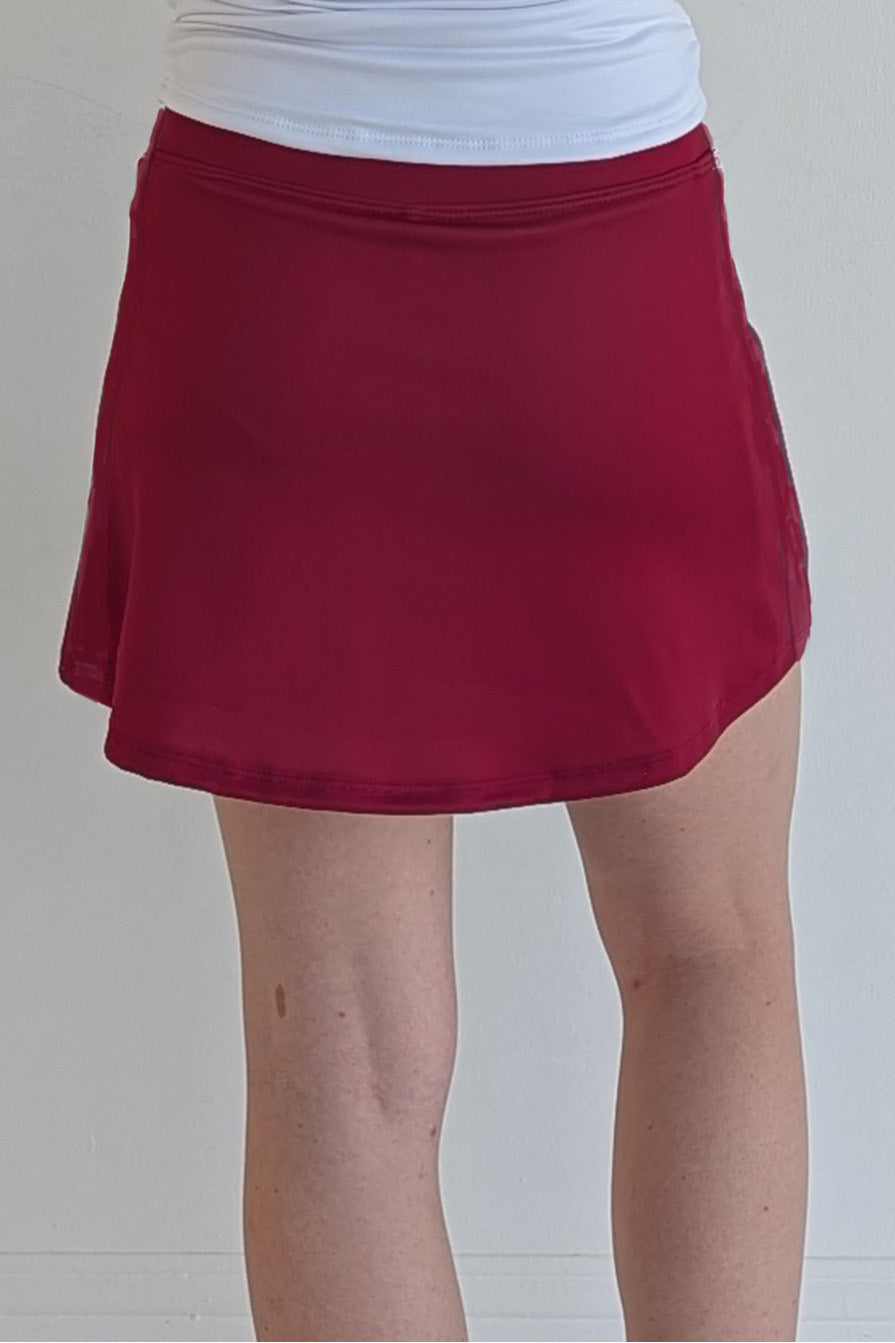 Form Fitting solid crimson miniskirt with built in shorts and pockets; great for gameday or hanging out with friends.