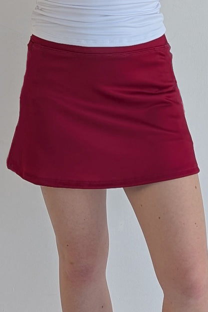 Form Fitting solid crimson miniskirt with built in shorts and pockets; great for gameday or hanging out with friends.