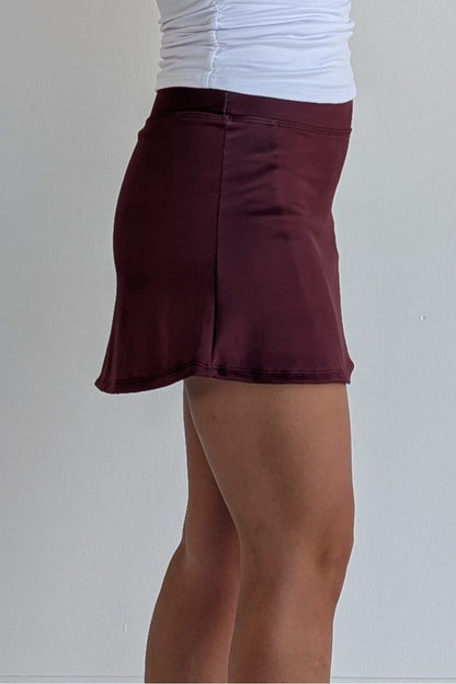 Form Fitting solid maroon miniskirt with built in shorts and pockets; great for gameday or hanging out with friends.