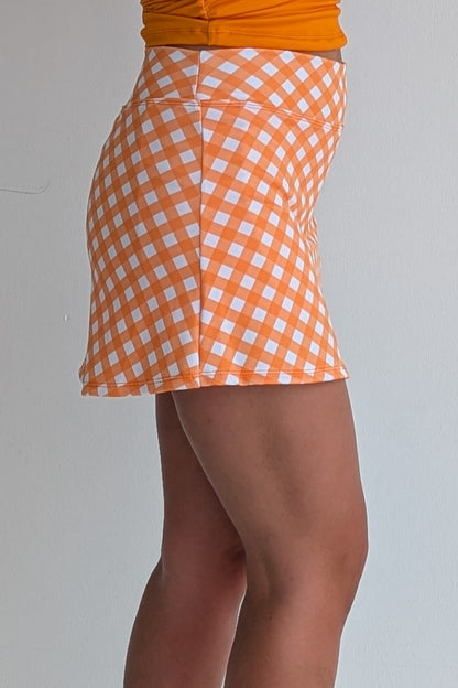 Form Fitting orange gingham miniskirt with  built in shorts and pockets; great for gameday or hanging out with friends.