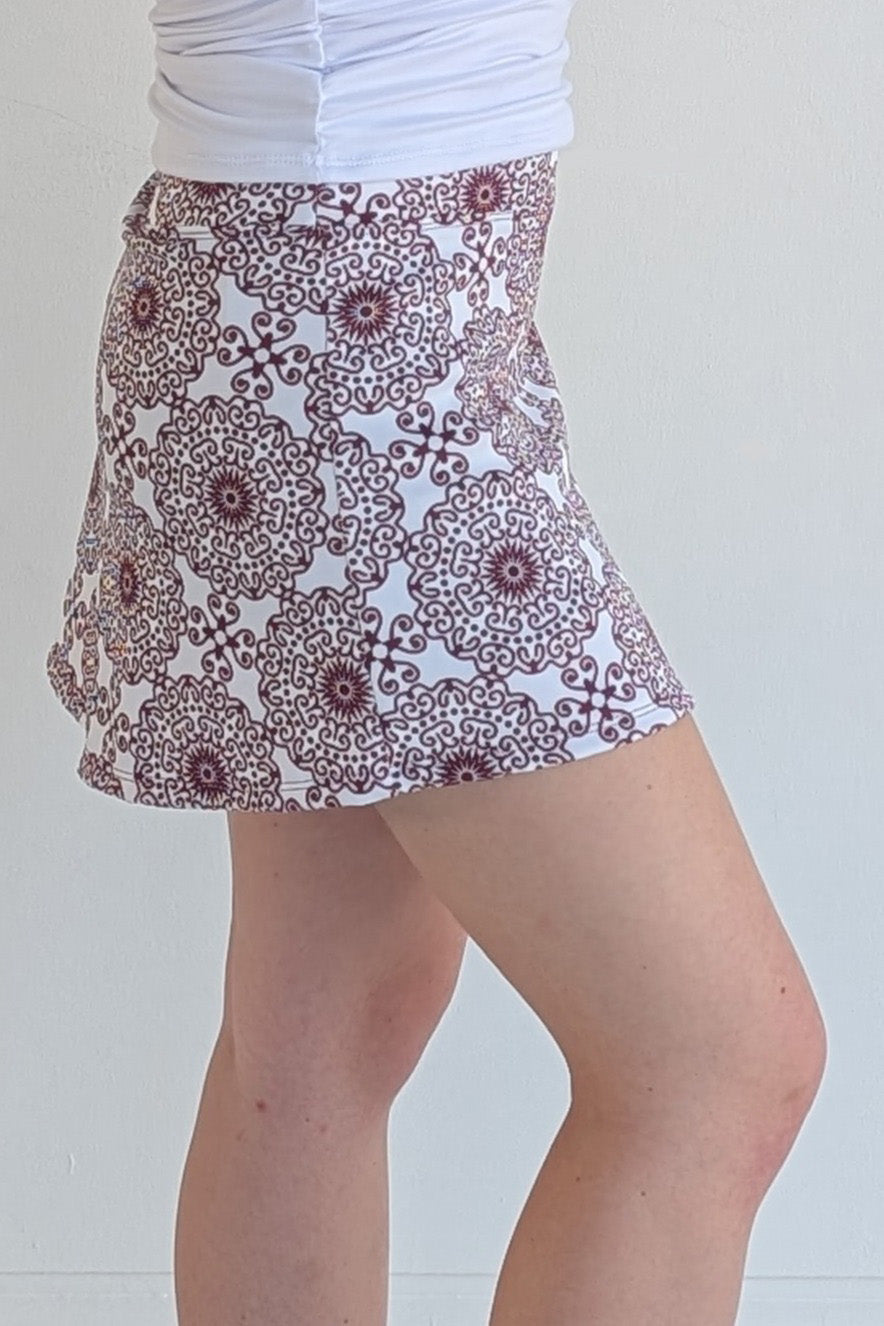 Form Fitting maroon miniskirt with scroll print and built in shorts and pockets; great for gameday or hanging out with friends.