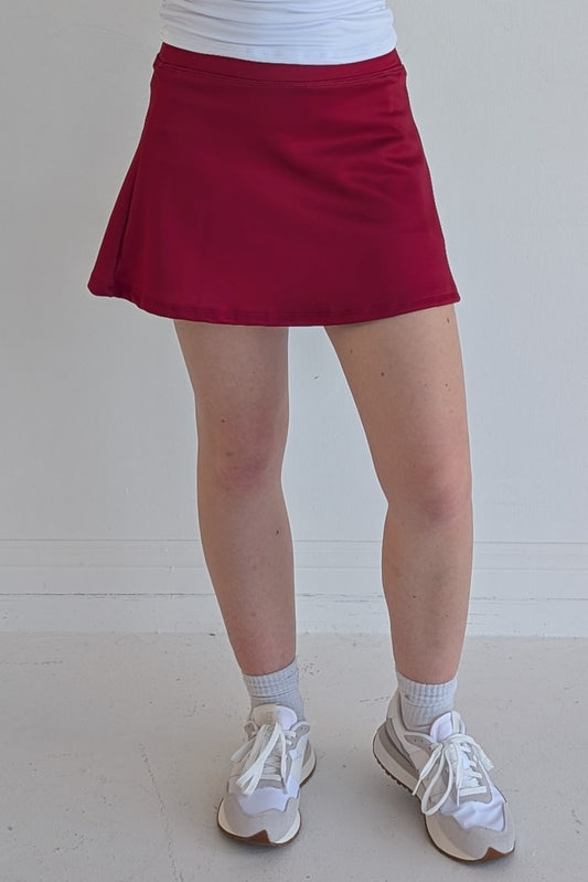 Relaxed back solid crimson miniskirt with built in shorts and pockets; great for gameday or hanging out with friends.
