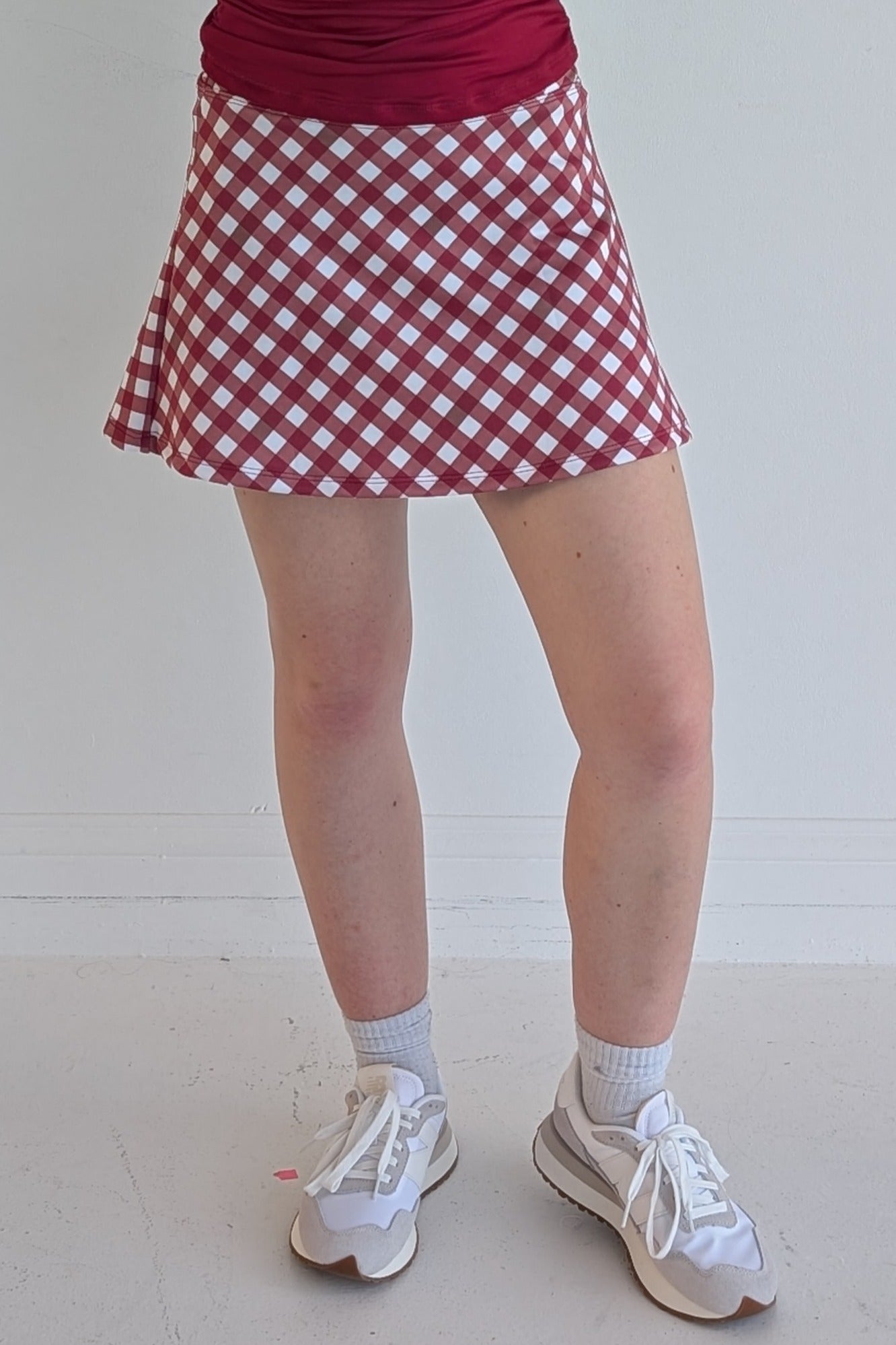 Relaxed back crimson gingham miniskirt with  built in shorts and pockets; great for gameday or hanging out with friends.