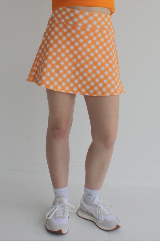 Relaxed back orange gingham miniskirt with  built in shorts and pockets; great for gameday or hanging out with friends.