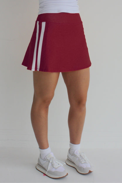 Relaxed back crimson miniskirt with side stripes and built in shorts and pockets; great for gameday or hanging out with friends.