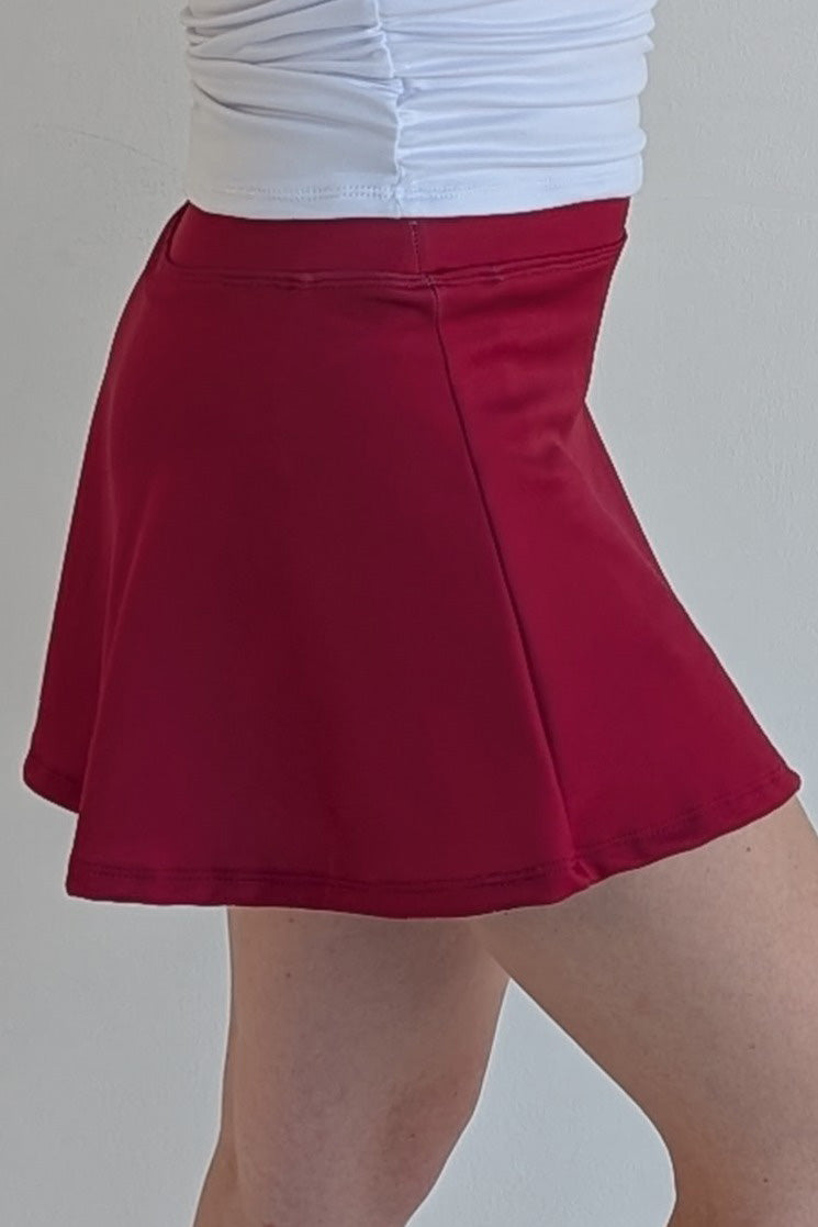Relaxed back solid crimson miniskirt with built in shorts and pockets; great for gameday or hanging out with friends.
