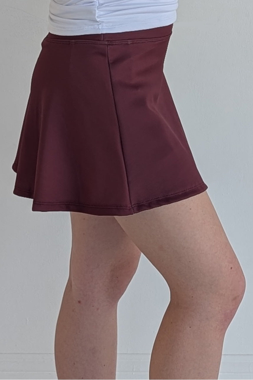 Relaxed back solid maroon miniskirt with built in shorts and pockets; great for gameday or hanging out with friends.