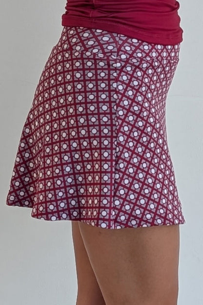 Relaxed back crimson miniskirt with geometric print and built in shorts and pockets; great for gameday or hanging out with friends.
