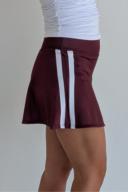 Relaxed back maroon miniskirt with side stripes and built in shorts and pockets; great for gameday or hanging out with friends.