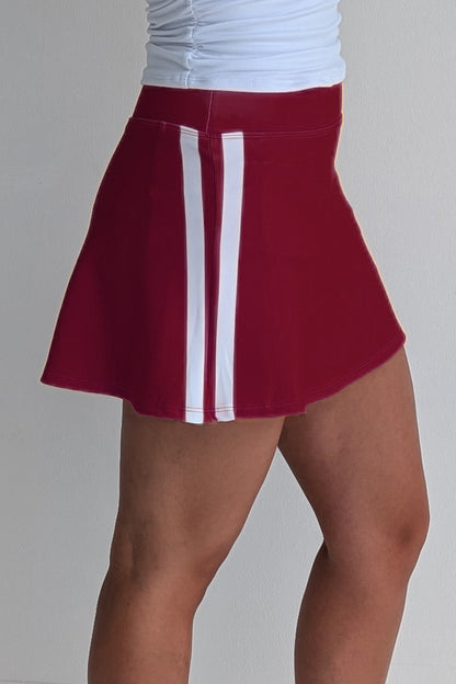 Relaxed back crimson miniskirt with side stripes and built in shorts and pockets; great for gameday or hanging out with friends.
