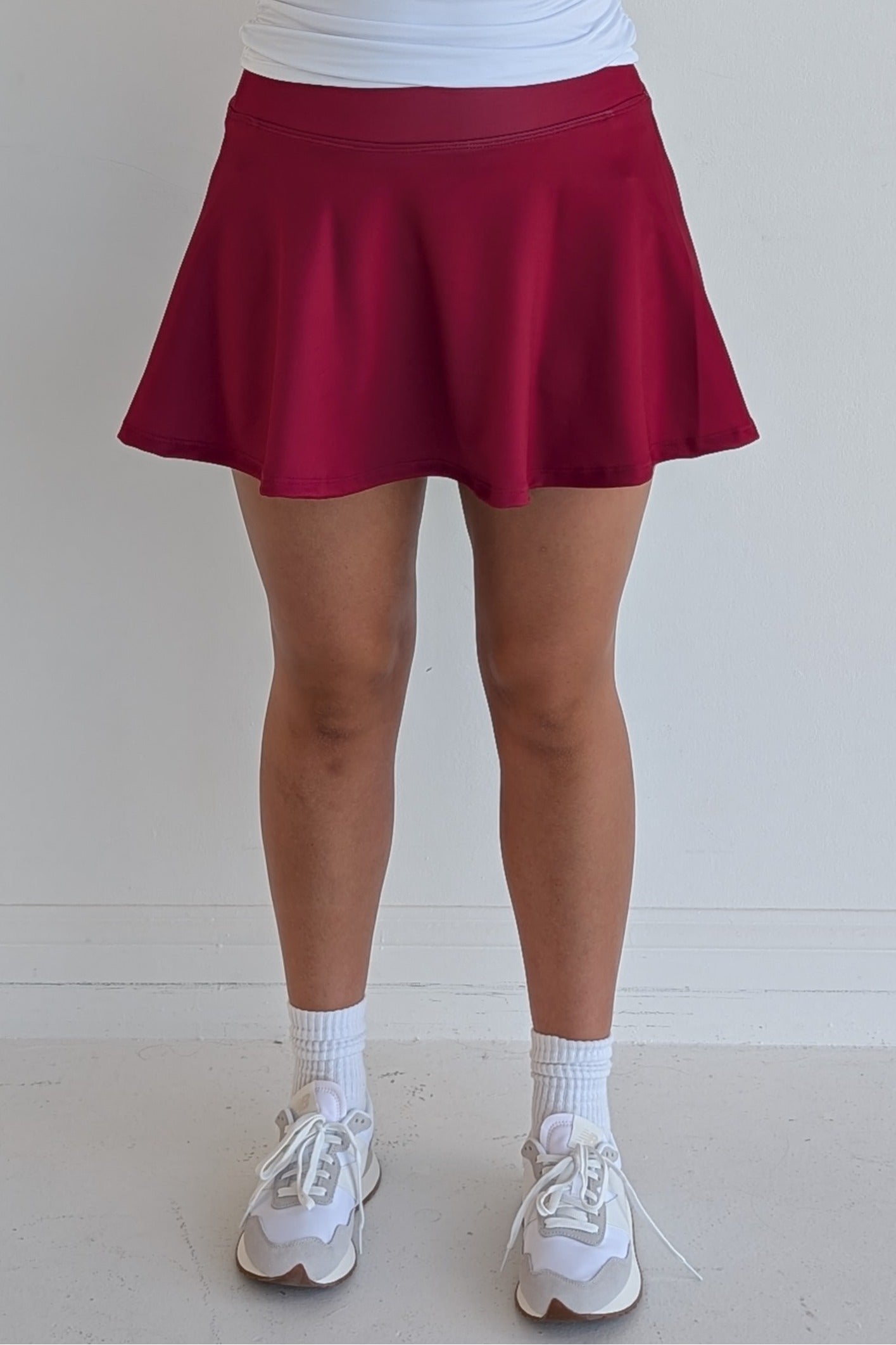 Full bodied solid crimson miniskirt with built in shorts and pockets; great for gameday or hanging out with friends.
