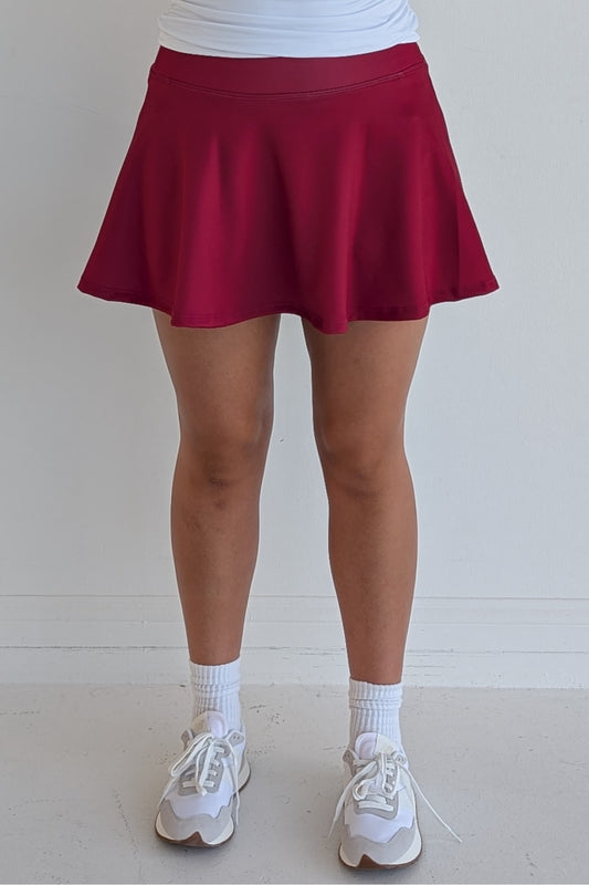 Full bodied solid crimson miniskirt with built in shorts and pockets; great for gameday or hanging out with friends.