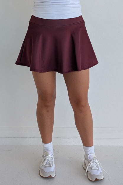 Full bodied solid maroon miniskirt with built in shorts and pockets; great for gameday or hanging out with friends.