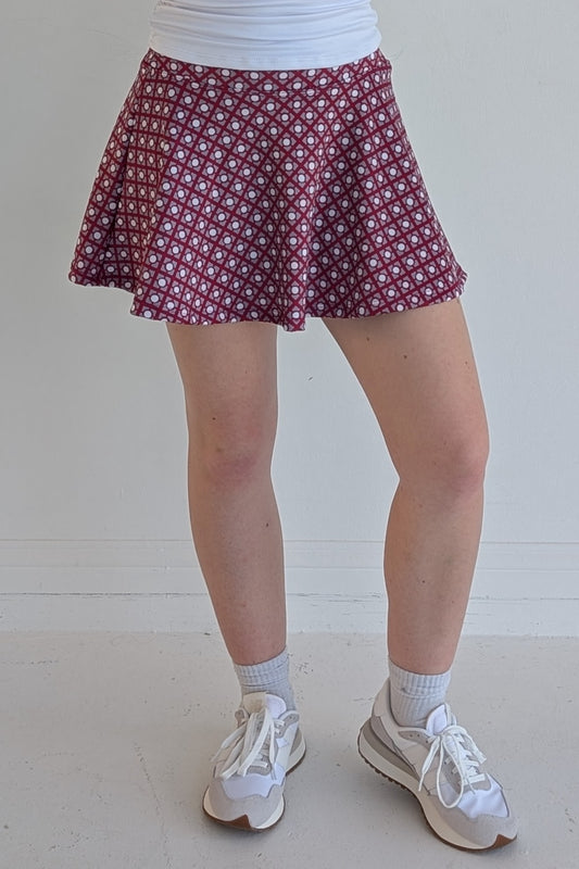 Full bodied crimson miniskirt with geometric print and built in shorts and pockets; great for gameday or hanging out with friends.