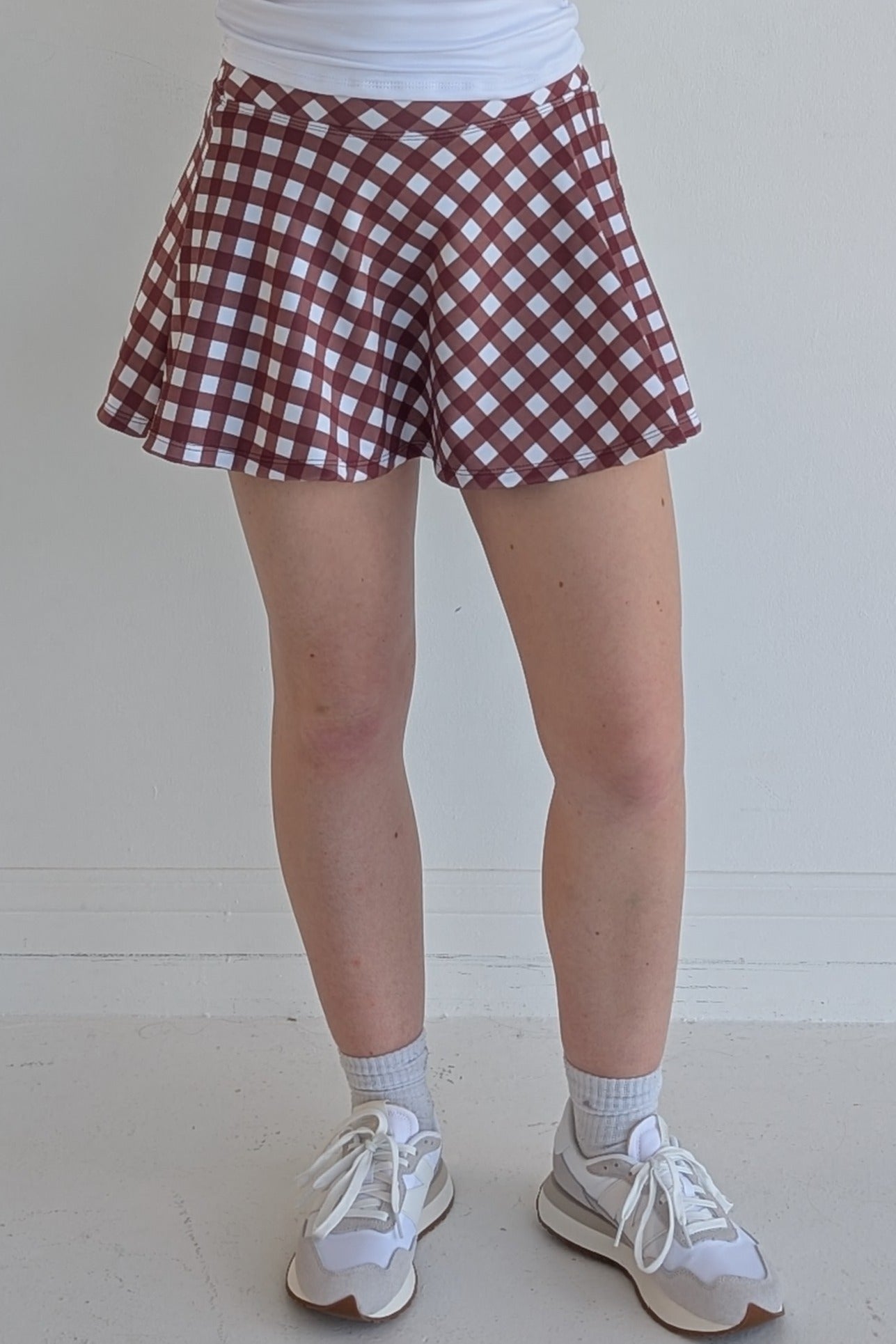 Full bodied maroon gingham miniskirt with  built in shorts and pockets; great for gameday or hanging out with friends.