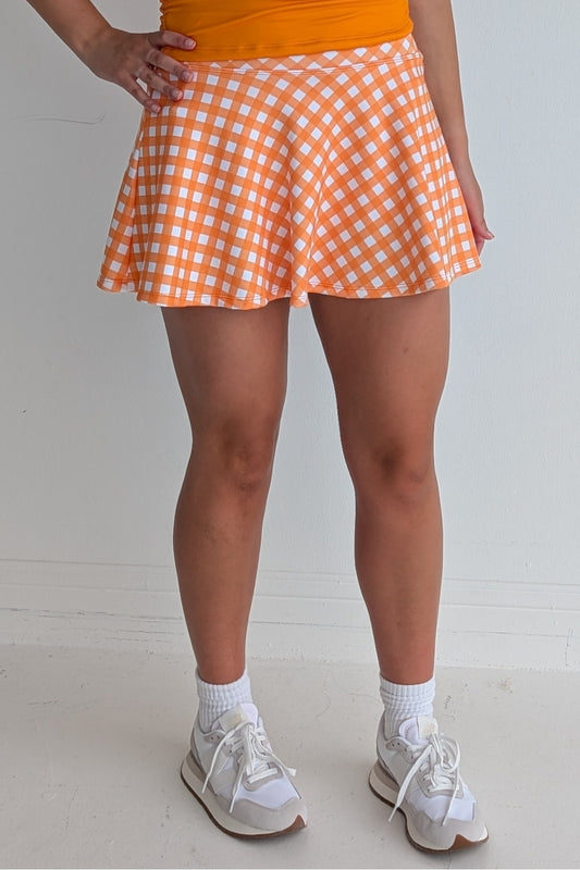 Full bodied orange gingham miniskirt with  built in shorts and pockets; great for gameday or hanging out with friends.