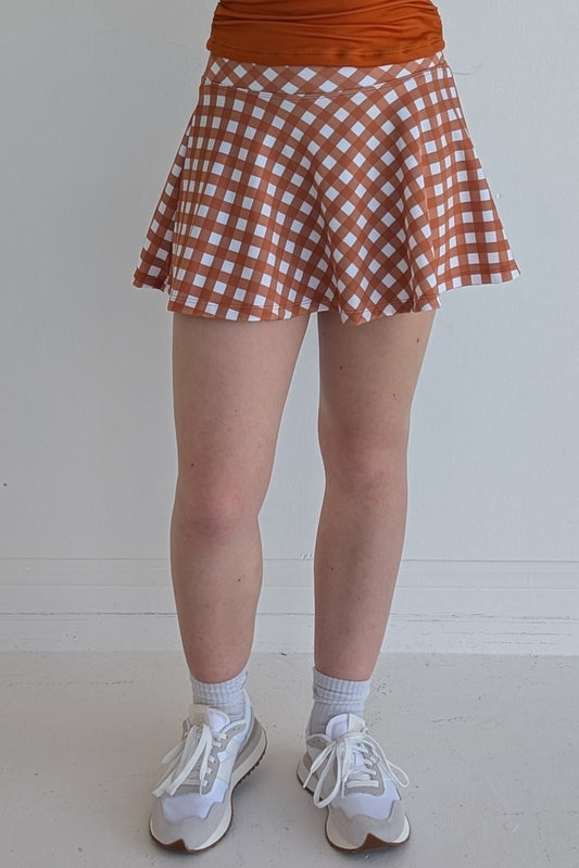 Full bodied burnt orange gingham miniskirt with  built in shorts and pockets; great for gameday or hanging out with friends.