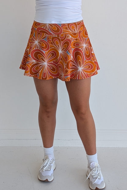 Full bodied burnt orange miniskirt with 70's inspired flower print and built in shorts and pockets; great for gameday or hanging out with friends.