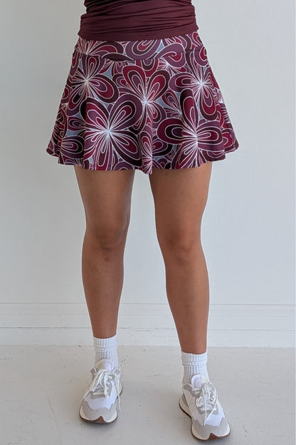 Full bodied maroon miniskirt with 70's inspired flower print and built in shorts and pockets; great for gameday or hanging out with friends.