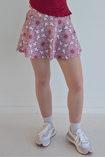 Full bodied crimson miniskirt with scroll print and built in shorts and pockets; great for gameday or hanging out with friends.