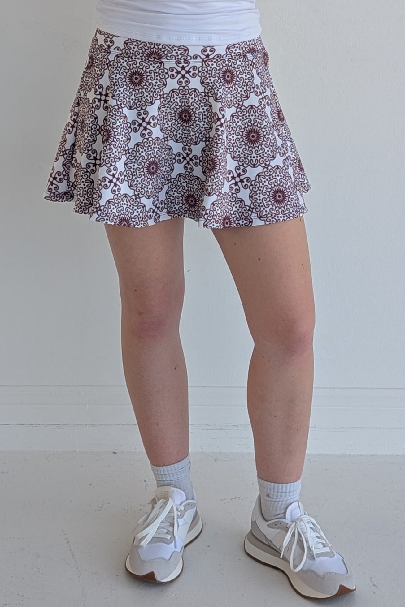 Full bodied maroon miniskirt with scroll print and built in shorts and pockets; great for gameday or hanging out with friends.