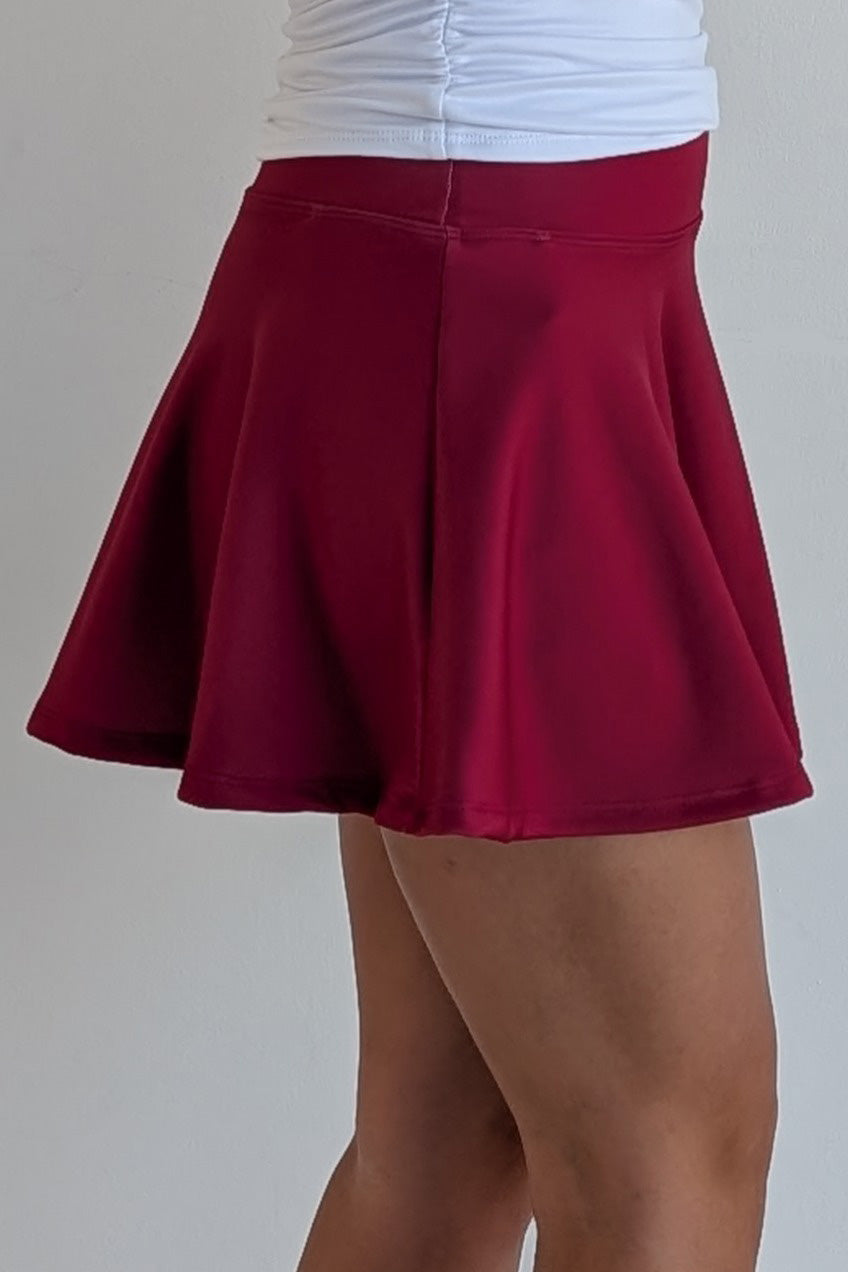 Full bodied solid crimson miniskirt with built in shorts and pockets; great for gameday or hanging out with friends.