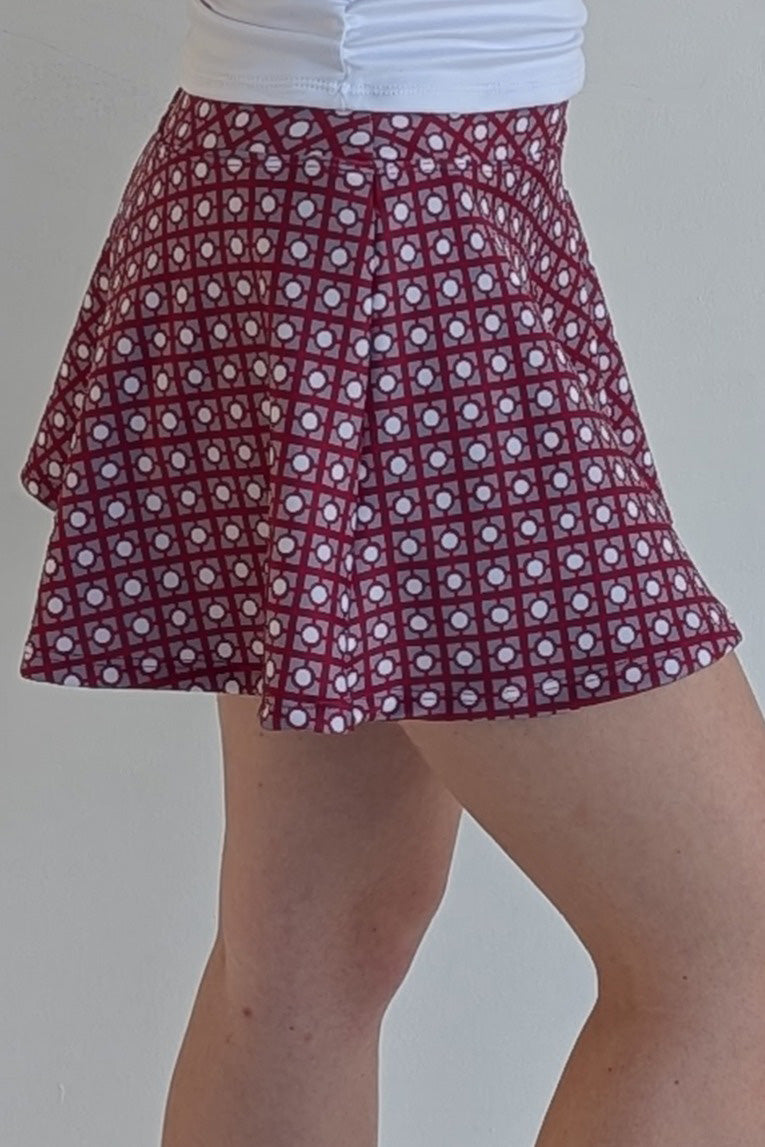 Full bodied crimson miniskirt with geometric print and built in shorts and pockets; great for gameday or hanging out with friends.