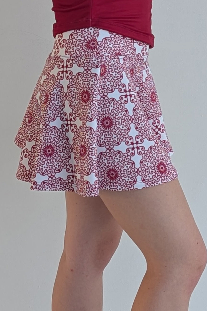 Full bodied crimson miniskirt with scroll print and built in shorts and pockets; great for gameday or hanging out with friends.