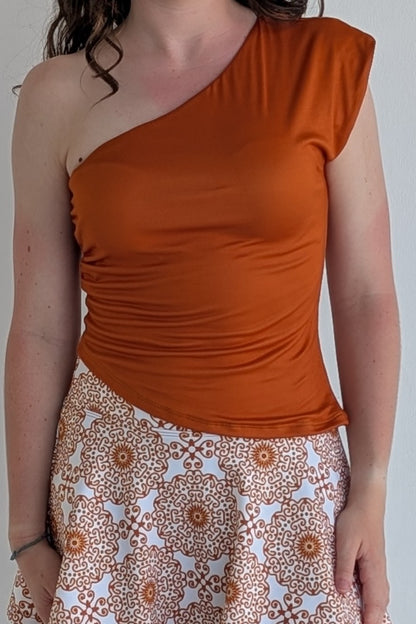 Asymmetric burnt orange single shoulder fully lined top; great for gameday or hanging out with friends.