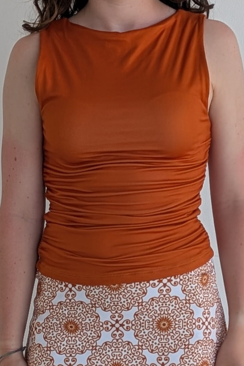 Boat neck burnt orange sleeveless fully lined top; great for gameday or hanging out with friends.