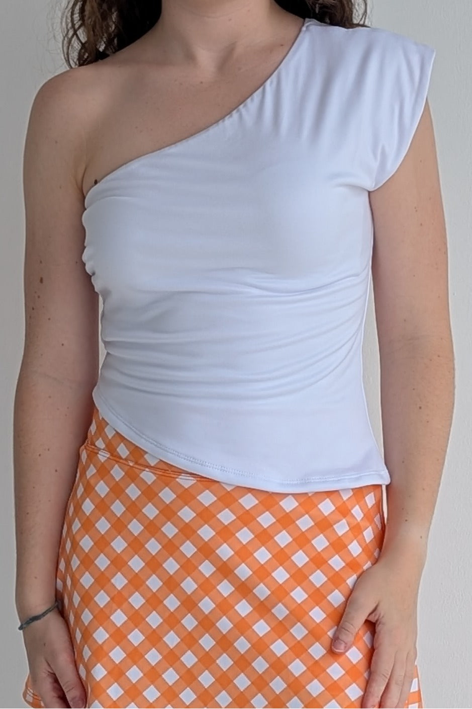Asymmetric white single shoulder fully lined top; great for gameday or hanging out with friends.