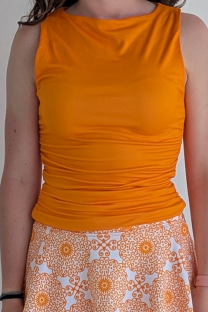 Boat neck orange sleeveless fully lined top; great for gameday or hanging out with friends.
